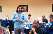 Shenandoah University Professor Bryan Pearce-Gonzales, Ph.D. standing, wearing a blue shirt.